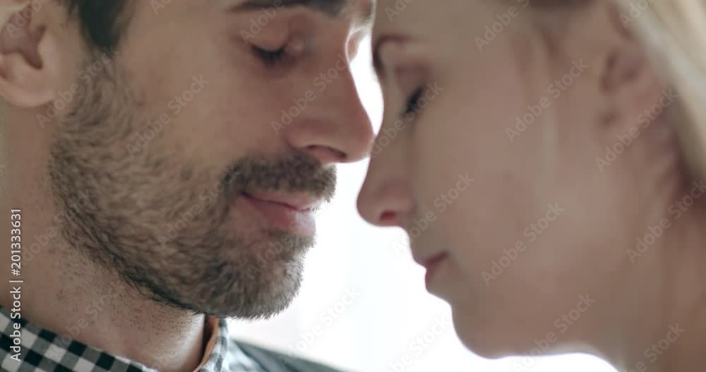 Man and woman toughing foreheads in tenderness with first the man and then the man breaking into a smile before they both begin laughing. Man and woman toughing foreheads in tenderness with first the man and then the man breaking into a smile before they both begin laughing.