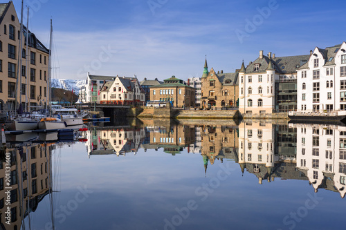 Architecture of Alesund town reflected in the water, Norway