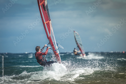 Photography Surfer riding waves in a beautiful sunny day