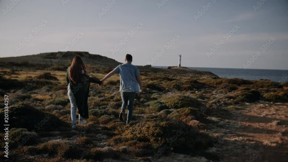 beautiful couple love each other in front of a lighthouse