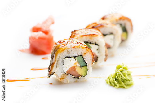 Seductive sushi rolls with eel, avocado and cucumber and Philadelphia cheese. Isolated. Sushi roll on a white background.