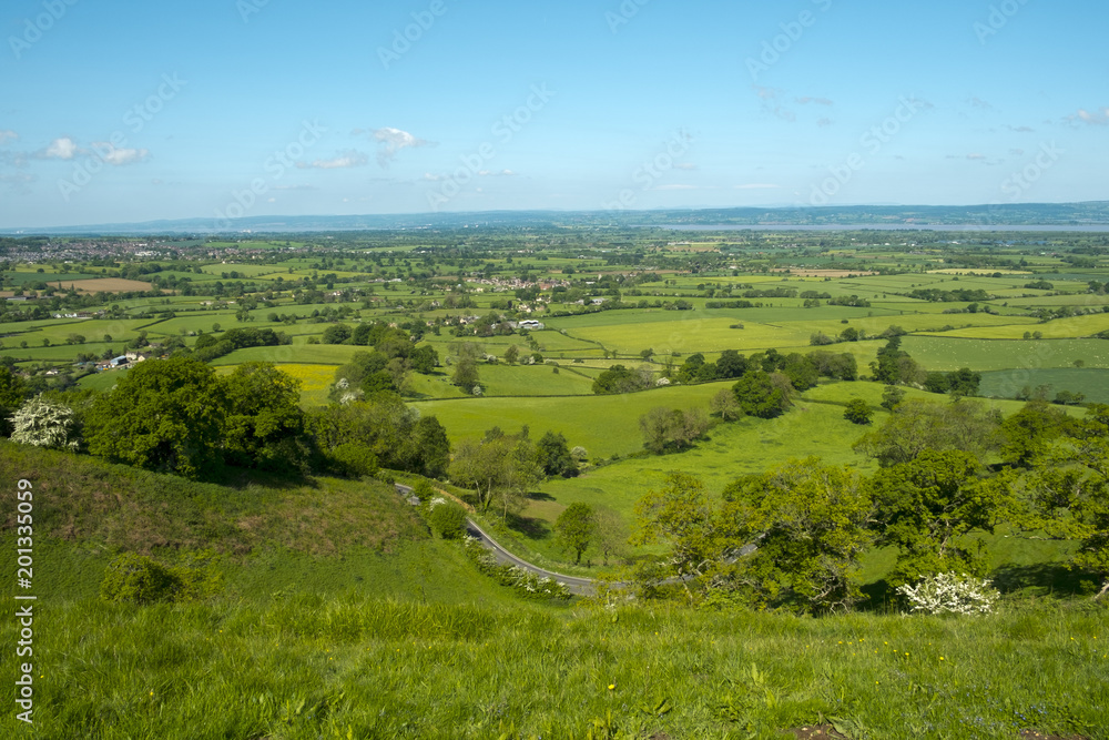 View over patchwork fields of The Severn Vale from Coaley Peak viewpoint near Nympsfield, Cotswolds, Gloucestershire, UK