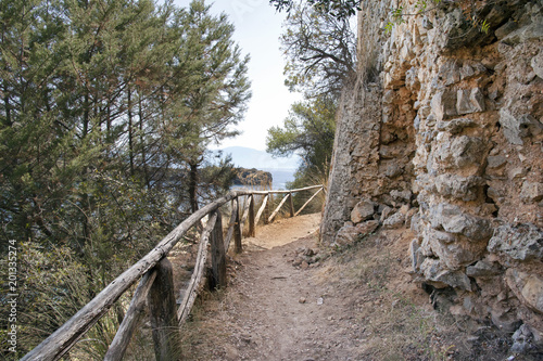 Dirt path to the seaside bordered by a wooden fence, Marina di Camerota, Italy
