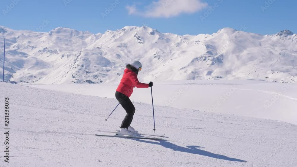 Woman Skis Carving Down The Slope In The Mountains Ski Resort At Winter Woman Skis Carving Down The Slope In The Mountains Ski Resort At Winter