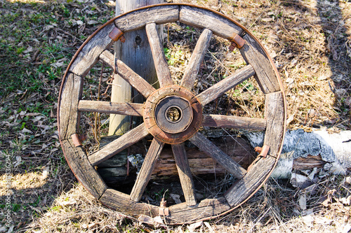 Old wooden cart wheel. The concept of outdated technologies, ecotourism