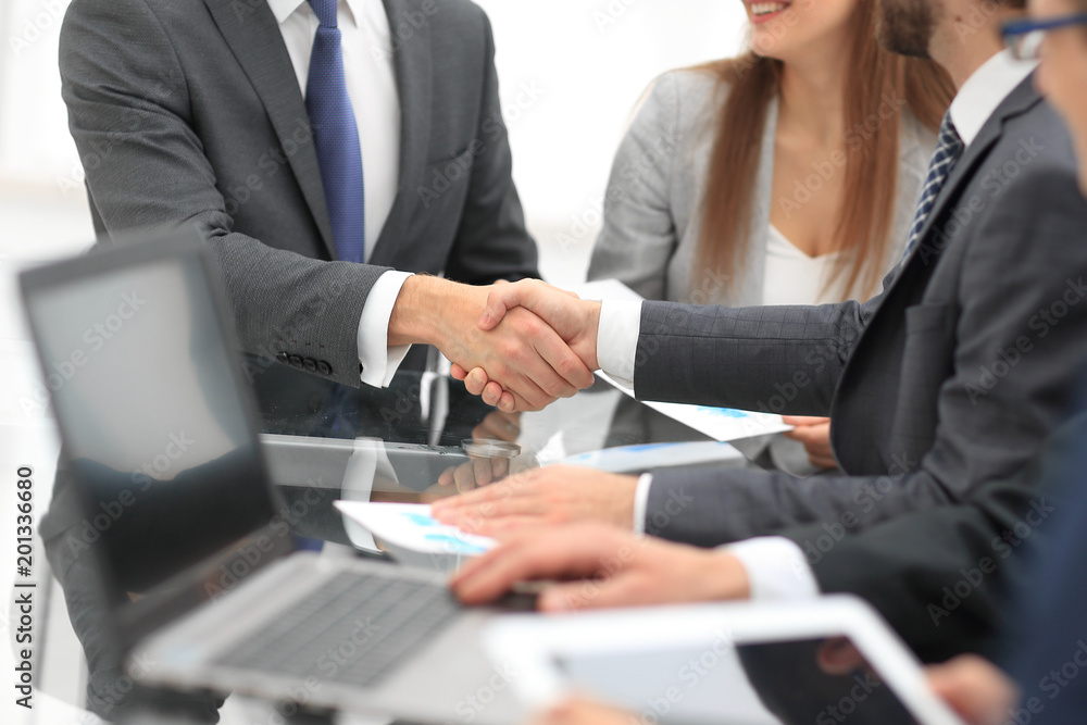 Business colleagues sitting at a table during a meeting with two Business colleagues sitting at a table during a meeting with two