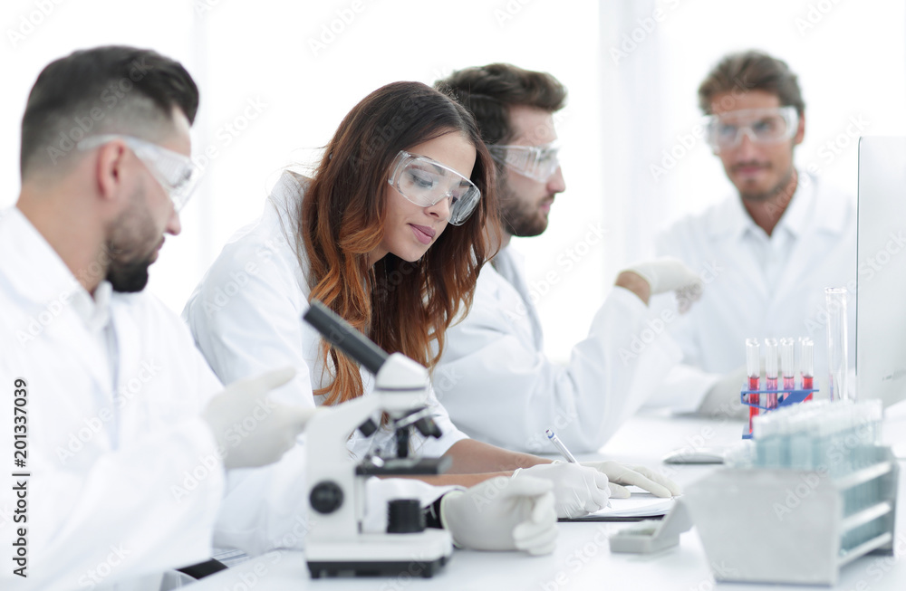 young scientists discussing the results of experiments in the laboratory young scientists discussing the results of experiments in the laboratory