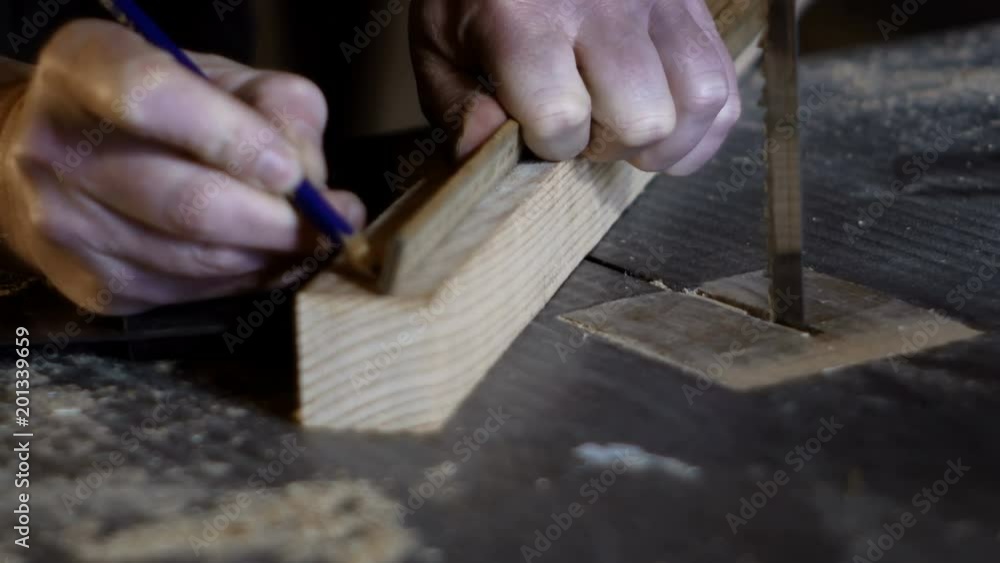 detail hands of a carpenter measuring with a carpenter's meter detail hands of a carpenter measuring with a carpenter's meter