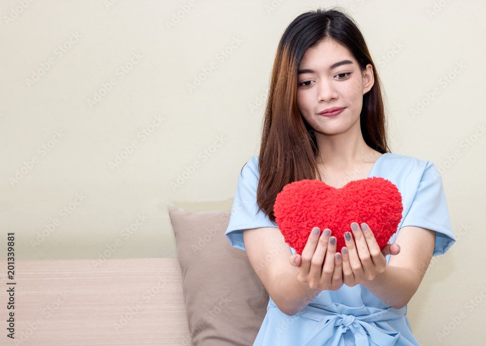women wake up and holding Heart pillow in the moring women wake up and holding Heart pillow in the moring