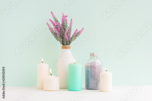 Spa composition. Candles, lavender flowers, sea salt on turquoise background. Flat lay, mock up. top view
