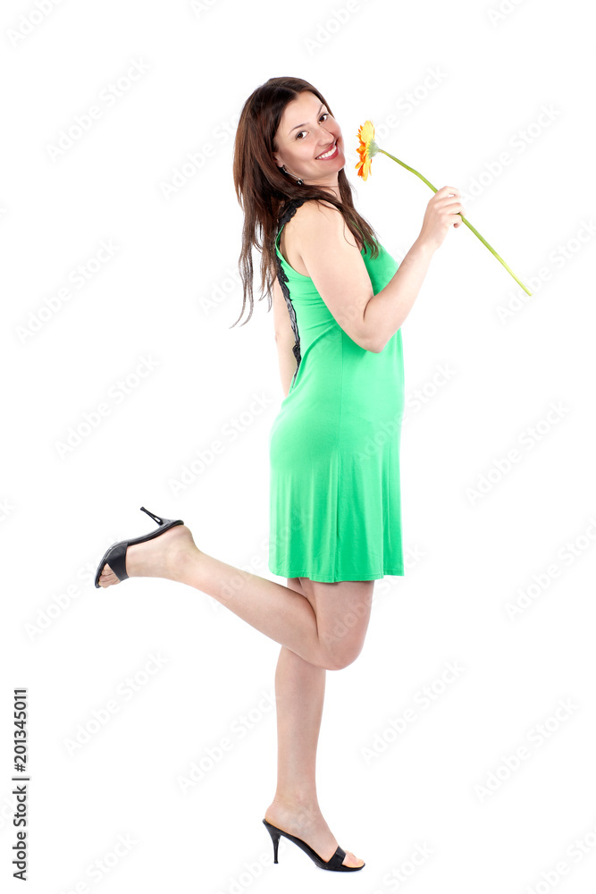 Beautiful woman in green dress, smiling and holding a flower, standing sideways with one foot up, full body, isolated on white background Beautiful woman in green dress, smiling and holding a flower, standing sideways with one foot up, full body, isolated on white background