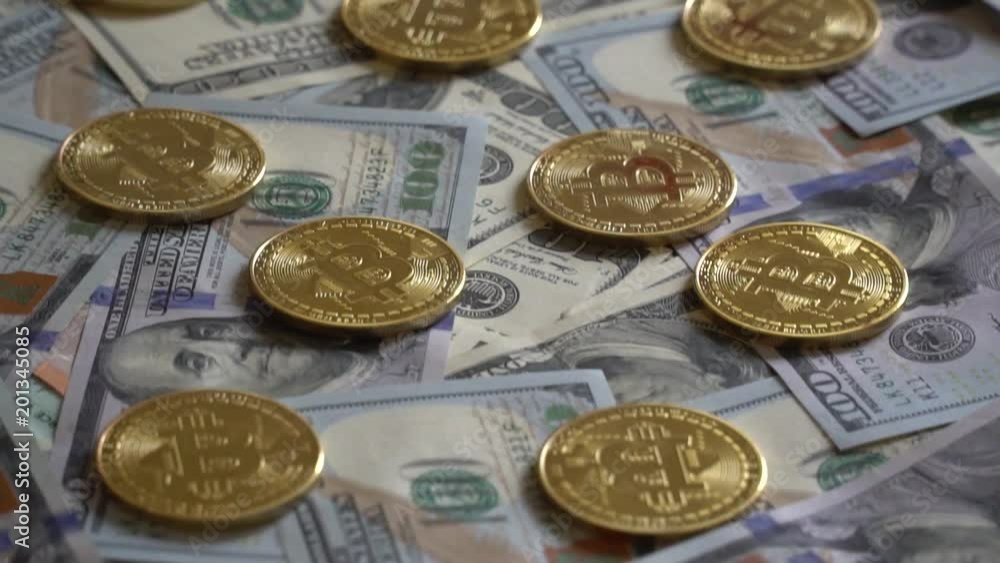Bit Coin BTC coins on bills of 100 dollars. Bit Coin BTC coins on bills of 100 dollars.