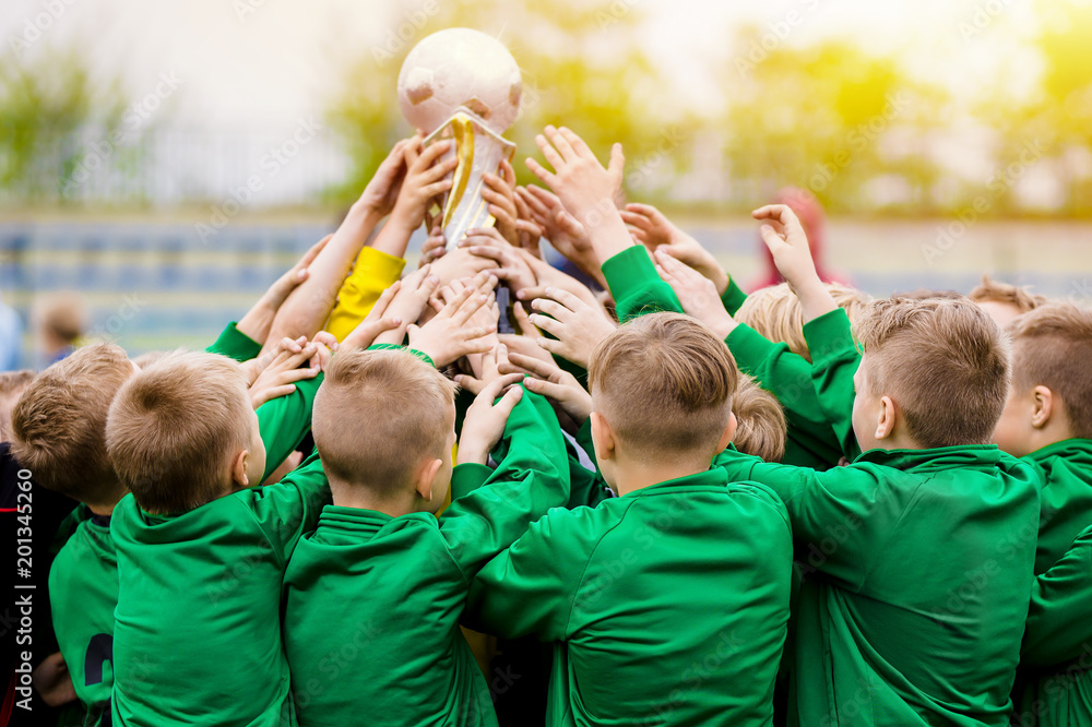 Kids Celebrating Soccer Victory. Young Football Players Holding Trophy