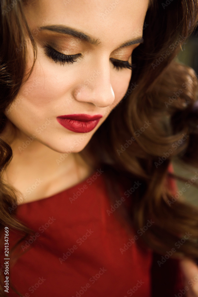 Hairdresser makes hairstyle girl with long hair in a beauty salon. Create curls with curling irons. Professional hair care. Hairdresser makes hairstyle girl with long hair in a beauty salon. Create curls with curling irons. Professional hair care.