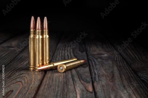 Cartridges on a wooden black background