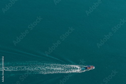 Top view of sailing red and white motorboat in the sea