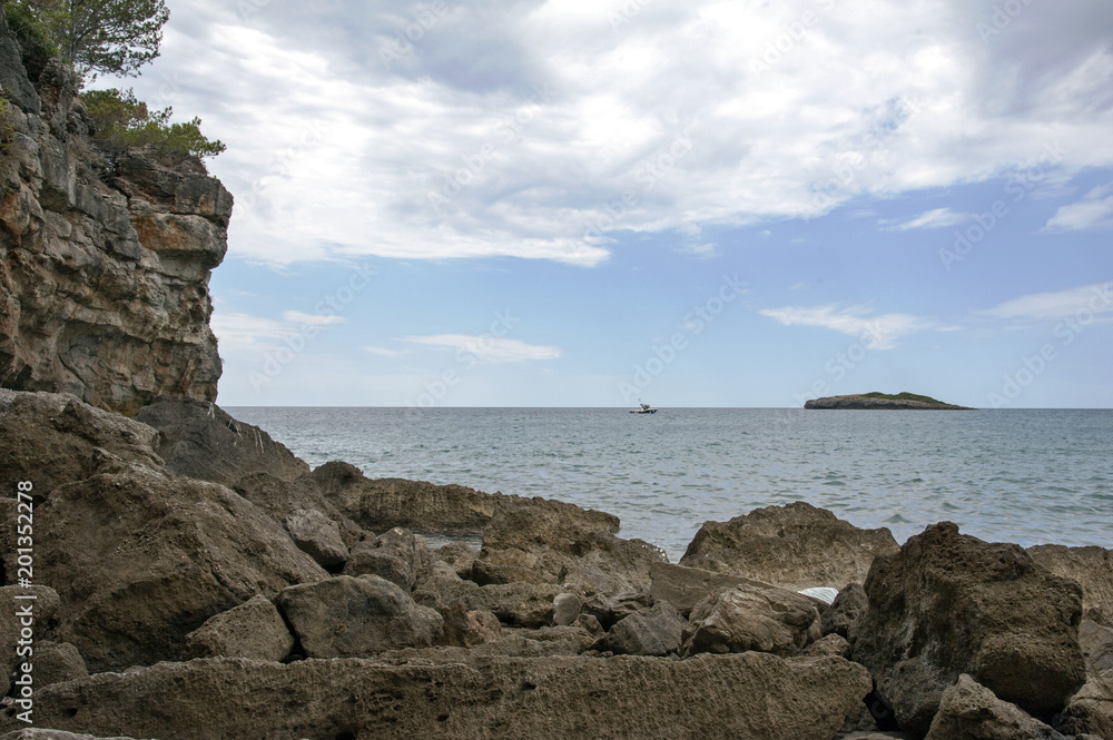 Islet in front of the rocky seaside