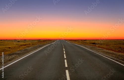 An empty asphalt road in the steppe at sunset. The Astrakhan region. Russia.