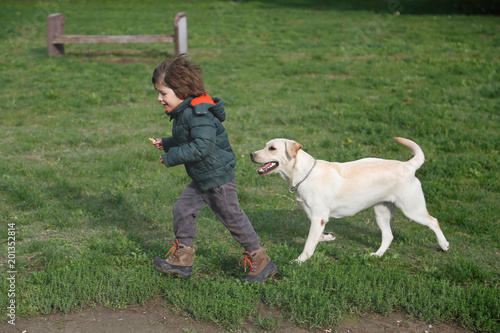 Little boy running with his labrador retriever © Nebojsa