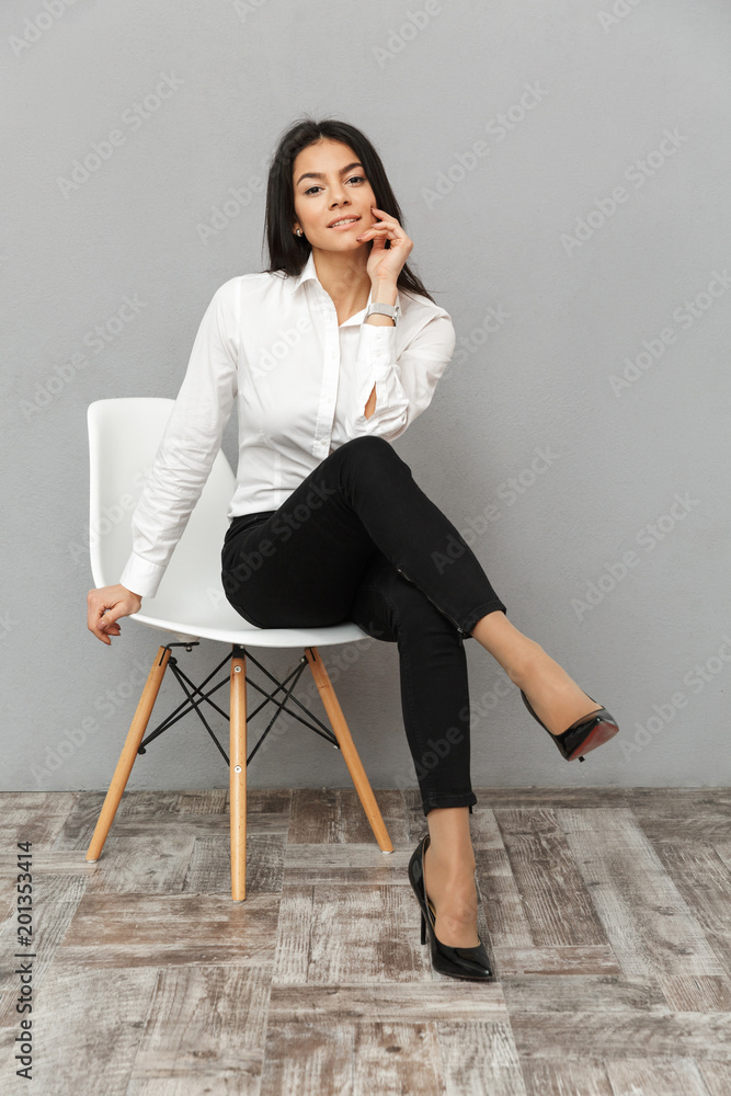 Full length image of stylish business woman in white shirt and