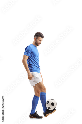 Soccer player juggling a football