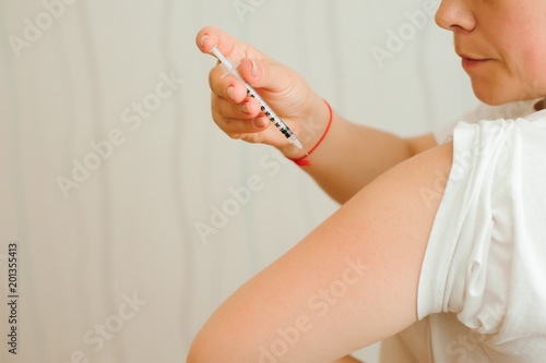 Insulin injection close-up. Girl injects insulin into his hand independently. Diabetes.