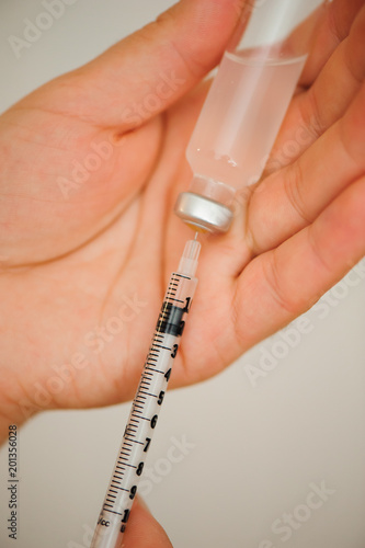 Girl picking up insulin in a syringe close-up. Diabetes.