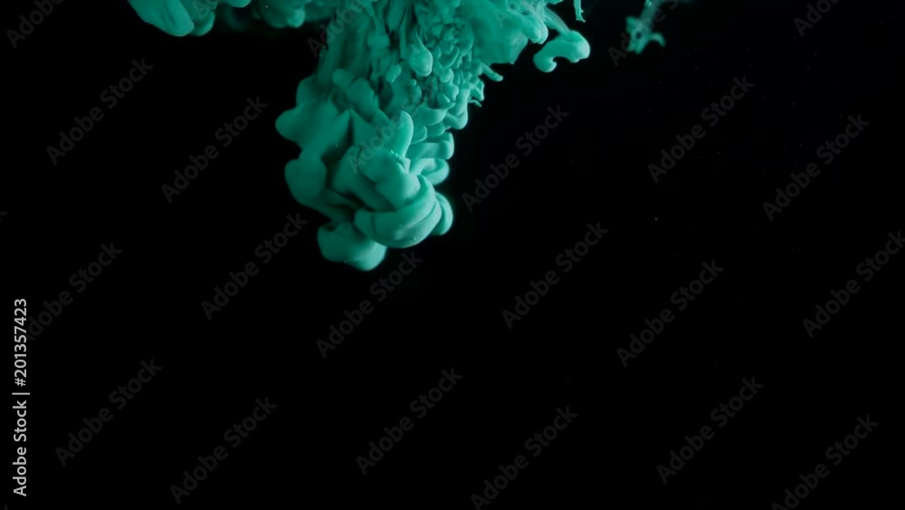 Turquoise ink in water shooting with high speed camera. Paint dropped ...
