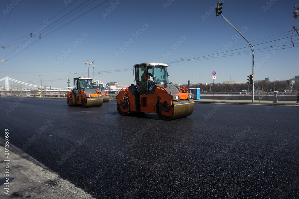 Road construction works with roller compactor machine and asphalt finisher Road construction works with roller compactor machine and asphalt finisher