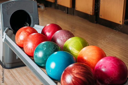 close-up shot of stand with colorful bowling balls in club