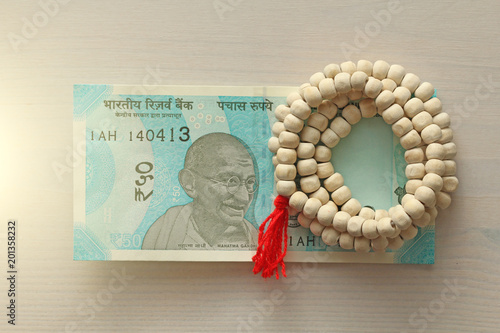 A new banknote of India with a denomination of 50 rupees. Indian currency. Mahatma Gandhi and rosary, beads of Tulasi tree photo