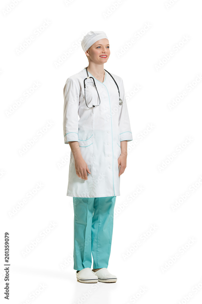 Beautiful young woman in white coat posing at studio. Full length studio shot isolated on white. Beautiful young woman in white coat posing at studio. Full length studio shot isolated on white.