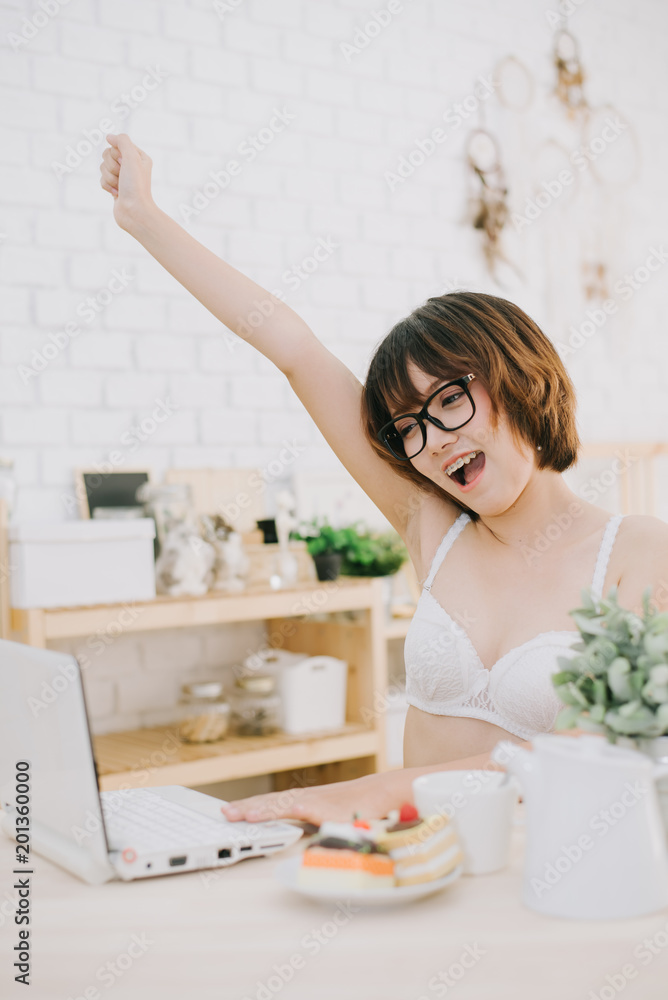 portrait of a young sexy beautiful and happy woman in bikini using laptop and lying portrait of a young sexy beautiful and happy woman in bikini using laptop and lying