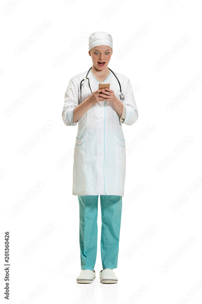 Beautiful young woman in white coat posing at studio. Full length studio shot isolated on white. Beautiful young woman in white coat posing at studio. Full length studio shot isolated on white.
