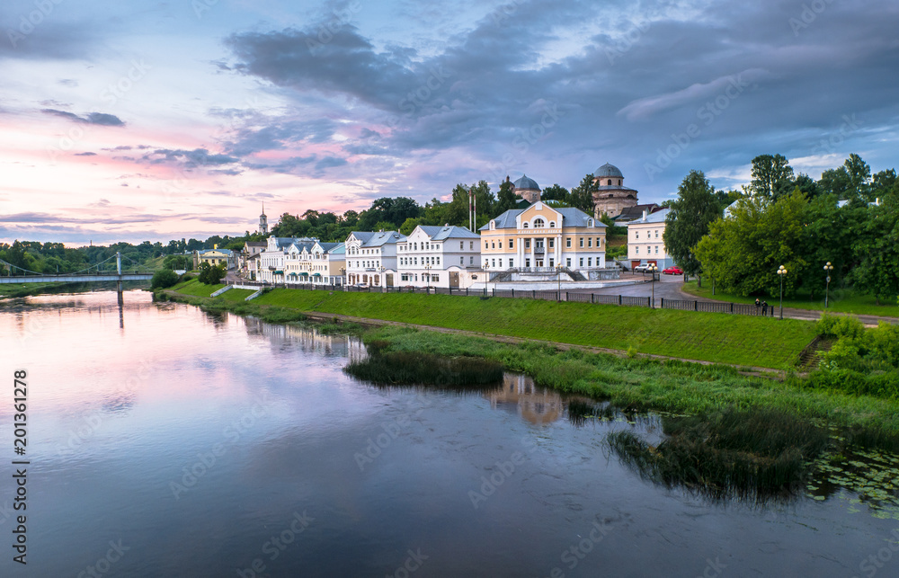 Dramatic sunset sky over the Tvertsa River and its picturesque shores after storm. Russian provincial town Torzhok, Tver region. Dramatic sunset sky over the Tvertsa River and its picturesque shores after storm. Russian provincial town Torzhok, Tver region.