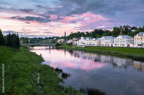 Dramatic sunset sky over the Tvertsa River and its picturesque shores after storm. Russian provincial town Torzhok, Tver region.