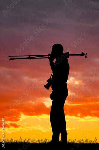 photographer with tripod at sunset