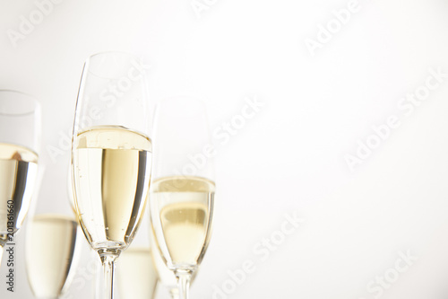 closeup view of champagne glasses isolated on white background