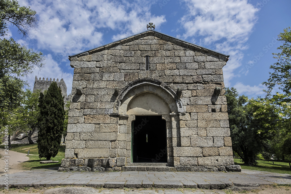 Fototapeta premium Romanesque Church of the Archangel Michael (Igreja de Sao Miguel do Castelo, 1216) in Castle of Guimaraes - medieval castle in the municipality Guimaraes, in the northern region of Portugal.