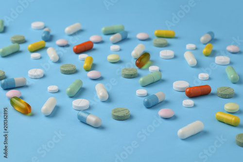 Unsorted pharmaceutical preparations on a blue background
