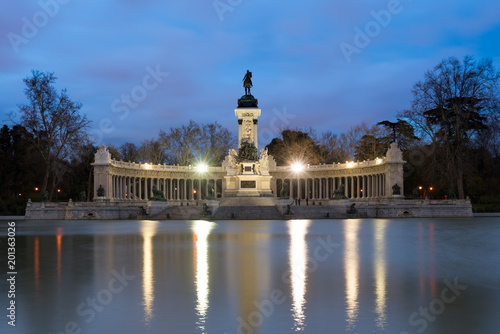 Night cityscape with lights at the memorial in Retiro city park, Madrid, Spain.