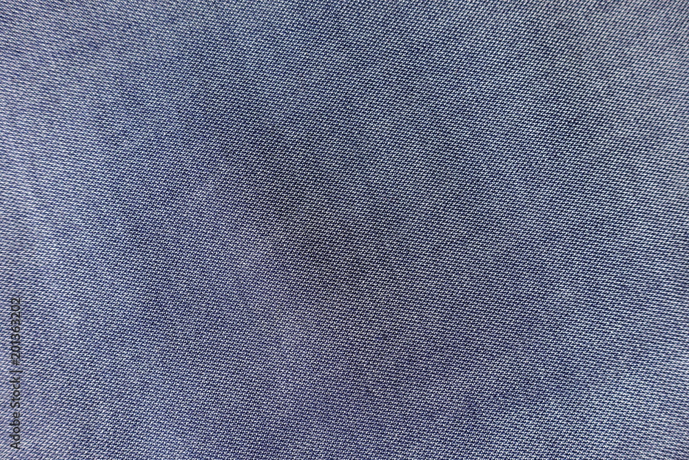 Texture of thin blue jeans fabric from above Texture of thin blue jeans fabric from above