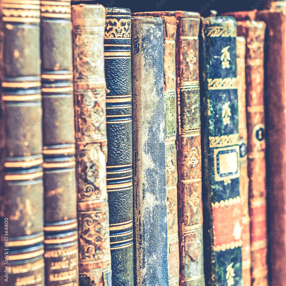 Old books background. Stack of books in a row. Old books background. Stack of books in a row.