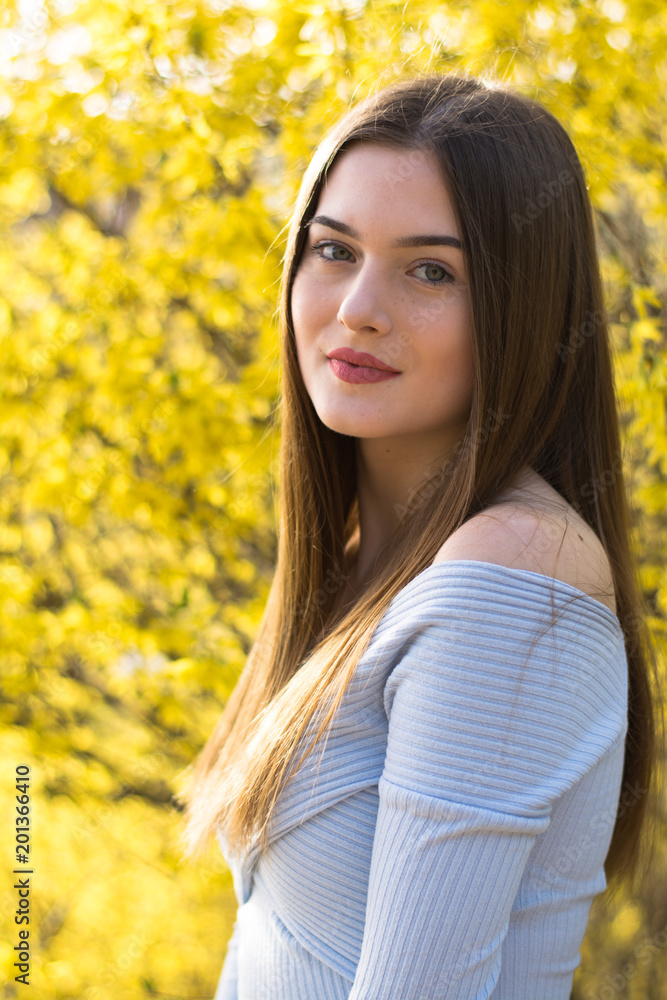 Young girl portrait with yellow bush Young girl portrait with yellow bush