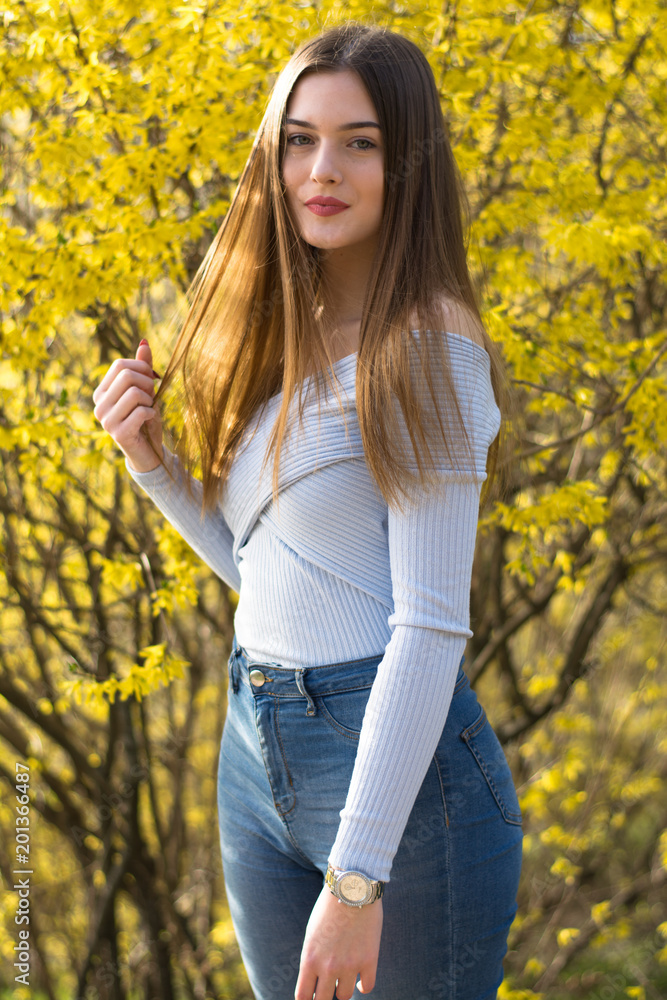 Young girl portrait with yellow bush Young girl portrait with yellow bush