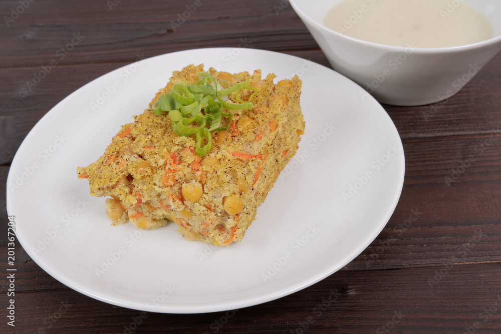 Polenta with poppy and vegetables on a table