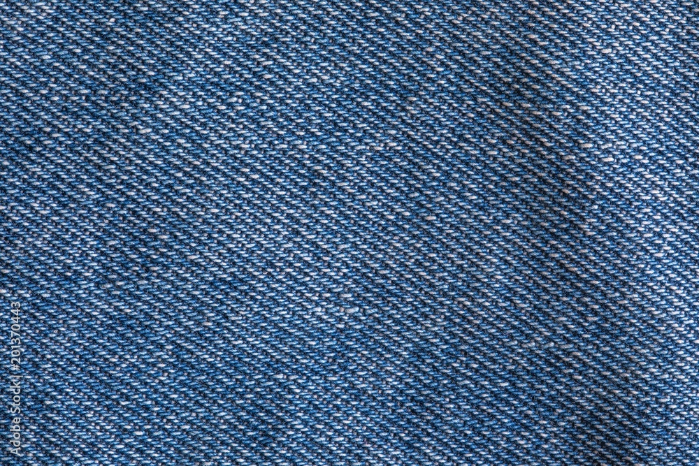 The blue jeans fiber texture. The macro shot is made by means of stacking technology The blue jeans fiber texture. The macro shot is made by means of stacking technology