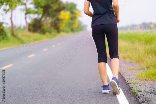 Woman feet running on road, Healthy fitness woman training