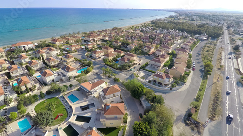 Seaside resort city, breathtaking aerial view of luxury cottages along coastline