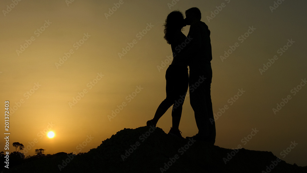Boyfriend and girlfriend kissing on sunset background, happy together forever